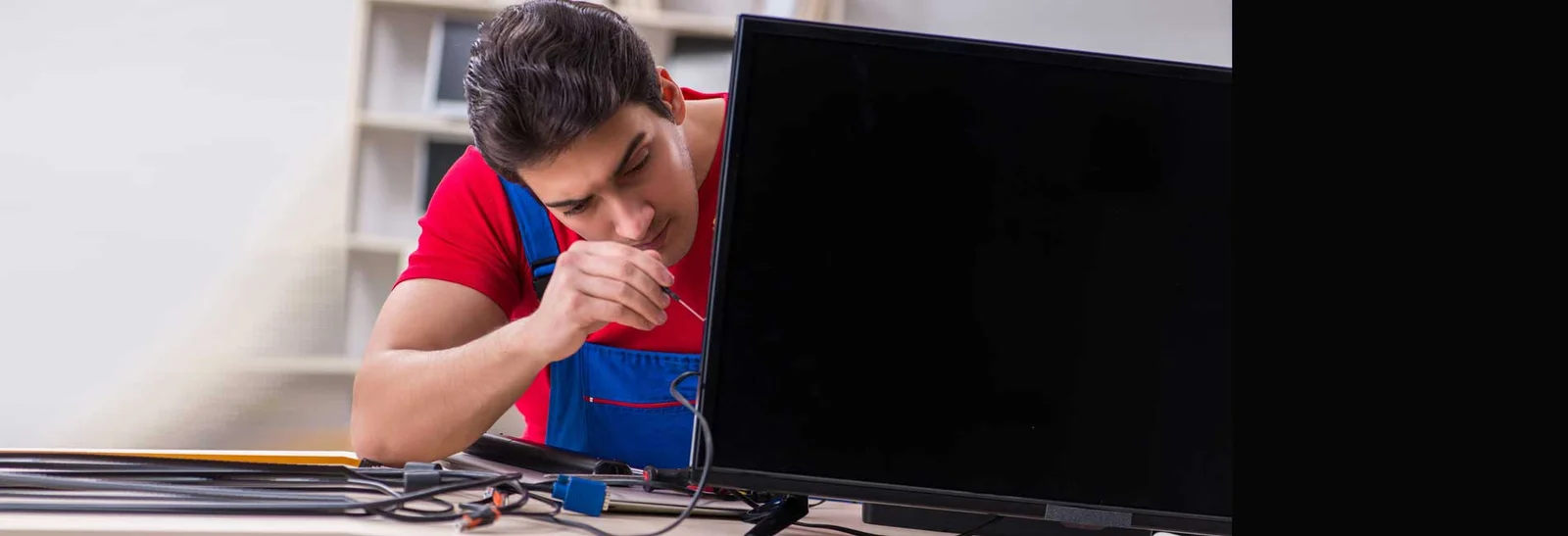 Technician repairing a TV at a customer's home in Greater Noida West
