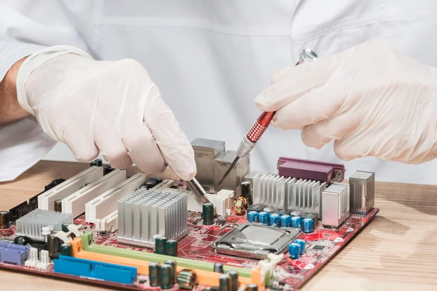 Prime Electronics Repair technician repairing a TV motherboard